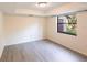 Bright bedroom with wood-look floors and a large window at 5131 Willow Leaf Dr, Sarasota, FL 34241