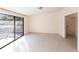 Spacious bedroom with sliding glass doors and carpet flooring at 5131 Willow Leaf Dr, Sarasota, FL 34241