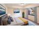 Bright bedroom featuring large wall art, comfortable bed, and a view to the outside at 5131 Willow Leaf Dr, Sarasota, FL 34241