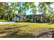 Tan house with a two-car garage and lush landscaping at 5131 Willow Leaf Dr, Sarasota, FL 34241