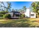 Back of house, showcasing a screened patio and landscaped yard at 5131 Willow Leaf Dr, Sarasota, FL 34241