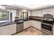Modern kitchen with white cabinets, granite counters, and stainless steel appliances at 5131 Willow Leaf Dr, Sarasota, FL 34241