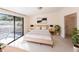 Bright main bedroom featuring white walls, a comfortable bed, and sliding glass doors at 5131 Willow Leaf Dr, Sarasota, FL 34241