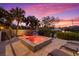 Waterfront home with a hot tub at sunset at 5246 Avenida Del Mare, Sarasota, FL 34242