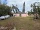 Pink house with solar panels and a large backyard at 543 11Th W Ave, Bradenton, FL 34205