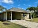 House exterior with carport and palm trees in the front yard at 5635 Alta Vista St, Sarasota, FL 34232