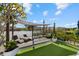 Relaxing backyard oasis with pergola, seating area, and lush landscaping at 609 Elba Dr, Nokomis, FL 34275