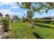 Spacious backyard with lush grass and a relaxing swing at 609 Elba Dr, Nokomis, FL 34275