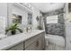 Modern bathroom with a tiled shower and quartz countertop at 609 Elba Dr, Nokomis, FL 34275