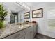 Modern bathroom with granite countertop and walk-in shower at 609 Elba Dr, Nokomis, FL 34275