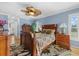 Bright bedroom with wooden bed frame and ceiling fan at 609 Elba Dr, Nokomis, FL 34275