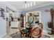 Bright dining area with glass table and four chairs, near the kitchen at 609 Elba Dr, Nokomis, FL 34275
