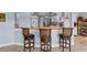 Kitchen with breakfast bar and three bar stools at 609 Elba Dr, Nokomis, FL 34275