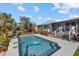 Inviting rectangular pool with surrounding patio and lush landscaping at 609 Elba Dr, Nokomis, FL 34275