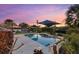 Inviting swimming pool area with tranquil water features and a picturesque sunset view at 609 Elba Dr, Nokomis, FL 34275