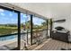 Relaxing screened porch overlooking the canal, pool, and lush tropical landscape at 609 Elba Dr, Nokomis, FL 34275