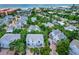 Stunning aerial view of a beach community with houses surrounded by lush green trees near the ocean at 6250 Holmes Blvd # 32, Holmes Beach, FL 34217