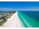 Stunning aerial view of the beach with clear turquoise water and white sand, perfect for coastal living at 6250 Holmes Blvd # 32, Holmes Beach, FL 34217