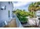 Enjoy the wooden balcony with seating, ideal for relaxing and overlooking the lush tropical foliage at 6250 Holmes Blvd # 32, Holmes Beach, FL 34217