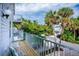 Relax on the spacious balcony with seating and enjoy the views of the surrounding palm trees and neighborhood at 6250 Holmes Blvd # 32, Holmes Beach, FL 34217