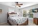 Charming bedroom featuring a queen size bed, ceiling fan and a bright, airy feel with large windows at 6250 Holmes Blvd # 32, Holmes Beach, FL 34217