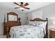 Comfortable bedroom features a queen bed, ceiling fan, dresser, and coastal-themed bedding at 6250 Holmes Blvd # 32, Holmes Beach, FL 34217