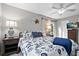 Light and airy bedroom with ceiling fan, coastal decor, TV, and a queen bed with blue accents at 6250 Holmes Blvd # 32, Holmes Beach, FL 34217