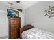 This bedroom features coastal decor, wood dresser, ceiling fan, and a single bed with themed bedding at 6250 Holmes Blvd # 32, Holmes Beach, FL 34217