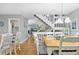 Open concept dining area with a staircase, a stylish light fixture, and views into the kitchen and living spaces at 6250 Holmes Blvd # 32, Holmes Beach, FL 34217