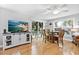 Bright dining room with a modern ceiling fan, hardwood floors, and sliding doors that let in natural light at 6250 Holmes Blvd # 32, Holmes Beach, FL 34217