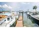 View of a dock with several boats and a charming picnic table setup, ideal for waterfront activities at 6250 Holmes Blvd # 32, Holmes Beach, FL 34217