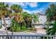 Charming townhouse boasts a garage and is surrounded by lush greenery and swaying palm trees at 6250 Holmes Blvd # 32, Holmes Beach, FL 34217