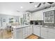 Modern kitchen with white cabinets, granite countertops, and stainless steel appliances at 6250 Holmes Blvd # 32, Holmes Beach, FL 34217