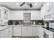 White shaker cabinets, granite countertops, and a tile backsplash highlight this kitchen at 6250 Holmes Blvd # 32, Holmes Beach, FL 34217