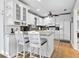 Bright kitchen featuring white cabinetry, granite countertops, stainless steel appliances, and an island with bar seating at 6250 Holmes Blvd # 32, Holmes Beach, FL 34217