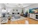 Comfortable living room with hardwood floors, plush seating, and a modern entertainment setup for relaxation and entertainment at 6250 Holmes Blvd # 32, Holmes Beach, FL 34217