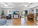 Cozy living room with a modern ceiling fan, hardwood floors, TV, and sliding doors for easy access to outdoor spaces at 6250 Holmes Blvd # 32, Holmes Beach, FL 34217
