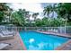 Community pool with plenty of lounge chairs at 6250 Holmes Blvd # 32, Holmes Beach, FL 34217