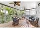 Relax on this screened porch with wicker furniture and ceiling fans, enjoying the beautiful outdoor views at 6250 Holmes Blvd # 32, Holmes Beach, FL 34217