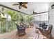 Spacious screened porch with wicker furniture, perfect for relaxing at 6250 Holmes Blvd # 32, Holmes Beach, FL 34217