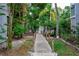 Wooden walkway leading through lush tropical landscaping at 6250 Holmes Blvd # 32, Holmes Beach, FL 34217