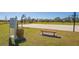 Outdoor basketball court featuring hoops, benches, trash can, and rules for a recreational activity at 6305 Royal Tern Cir, Lakewood Ranch, FL 34202