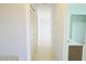 A long hallway with tile flooring and two closets at 6887 Ketona Rd, North Port, FL 34287