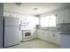 Updated kitchen boasts white cabinets and granite countertops at 6887 Ketona Rd, North Port, FL 34287