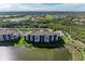 Aerial view of building near golf course and water at 7005 River Hammock Dr # 103, Bradenton, FL 34212