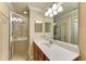 Bathroom with walk in shower and double vanity at 7005 River Hammock Dr # 103, Bradenton, FL 34212