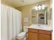 Clean bathroom with shower/tub combo, toilet and wood vanity at 7005 River Hammock Dr # 103, Bradenton, FL 34212