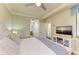 Main bedroom with TV, and en-suite bathroom access at 7005 River Hammock Dr # 103, Bradenton, FL 34212