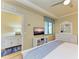Bedroom with TV, dresser, and en-suite bathroom access at 7005 River Hammock Dr # 103, Bradenton, FL 34212