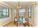 Cozy breakfast nook with glass table and wicker chairs, overlooking peaceful scenery at 7005 River Hammock Dr # 103, Bradenton, FL 34212